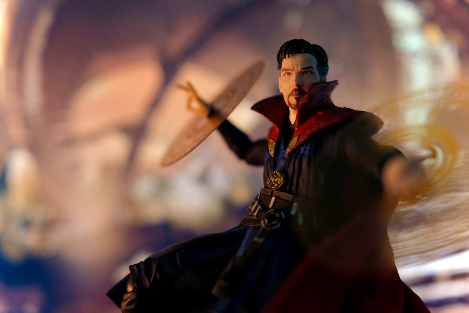 Doctor Strange action figure posed mid-spell with magical effects in a cinematic setting.